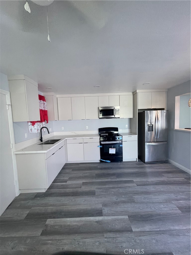 3334 139th Street Hawthorne, CA 90250 - Photo 6 of 15 a kitchen with granite countertop a sink cabinets and stainless steel appliances