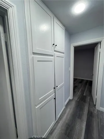 a view of a hallway with wooden floor