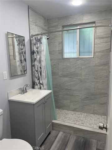 a bathroom with a sink toilet and shower