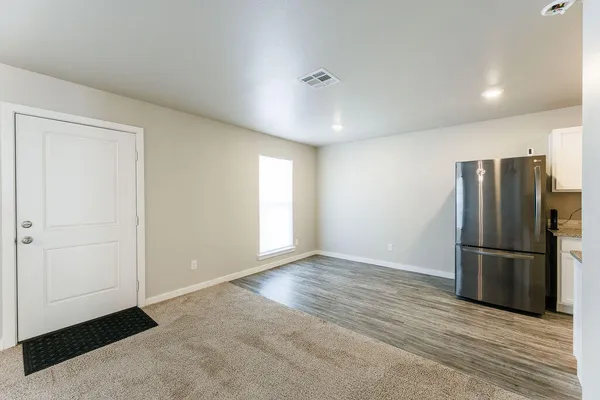 a kitchen with stainless steel appliances granite countertop a sink stove microwave and refrigerator