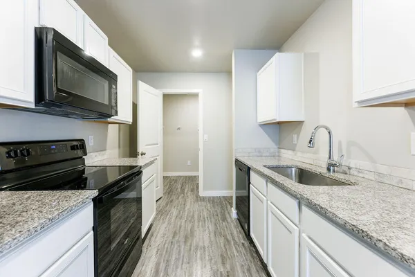 a kitchen with a stove and a microwave