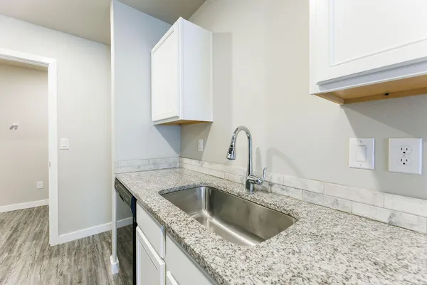 a kitchen with cabinets and a stove