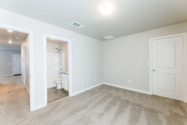 a bathroom with a granite countertop toilet sink and shower