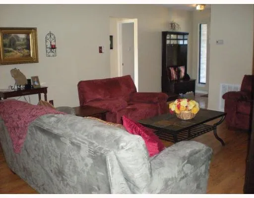 a living room with furniture flowerpot and a dining table