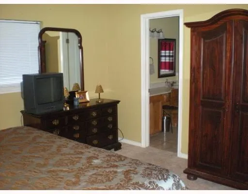 a bedroom with a bed and a mirror