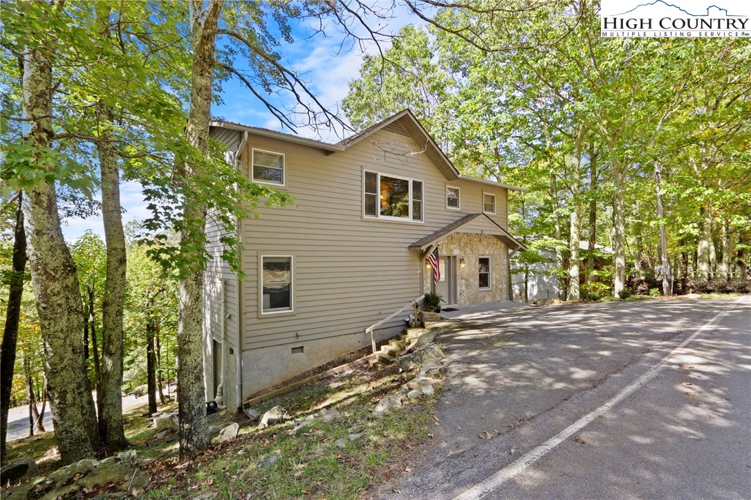 504 St Andrews Road Beech Mountain, NC 28604 - Photo 42 of 43 a view of a house with a yard