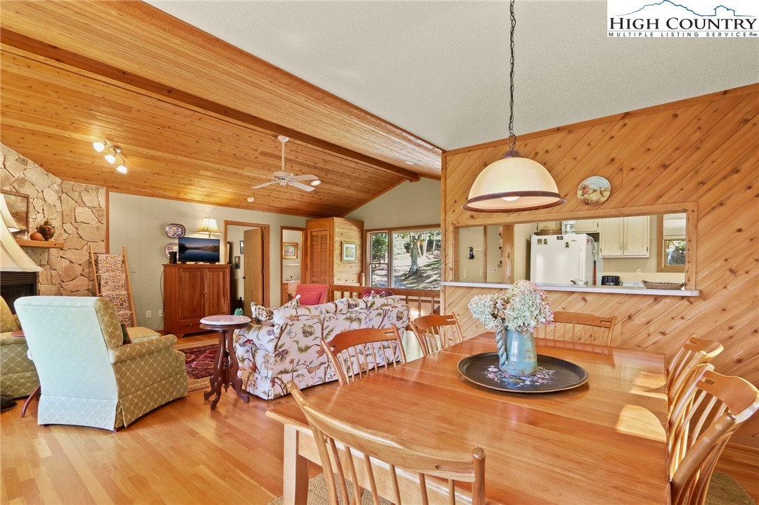 504 St Andrews Road Beech Mountain, NC 28604 - Photo 10 of 43 a view of a dining room with furniture a chandelier and wooden floor