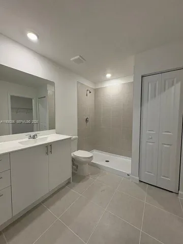 a bathroom with a toilet sink and shower