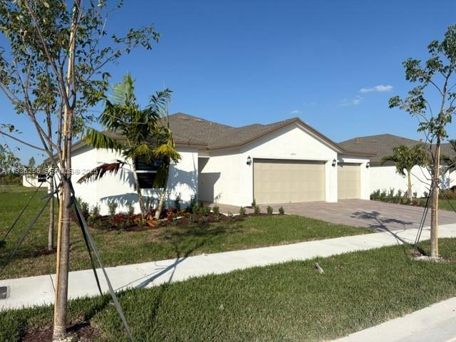 17435 Southwest 285th Street Homestead, FL 33033 - Photo 2 of 24 a front view of a house with a yard