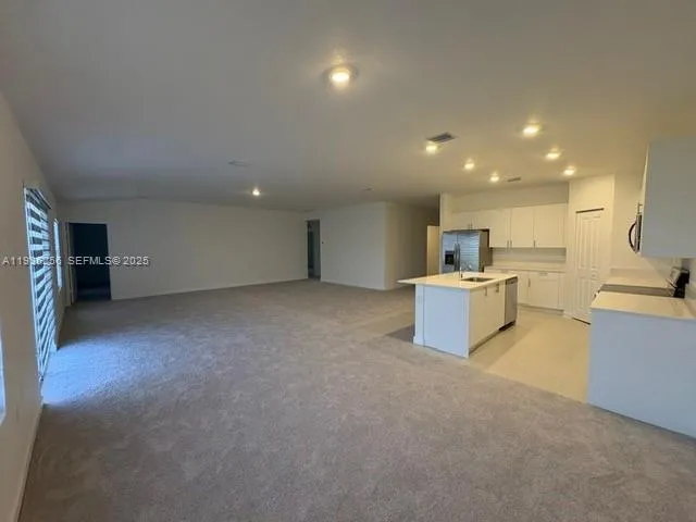 a view of a kitchen with furniture and a kitchen