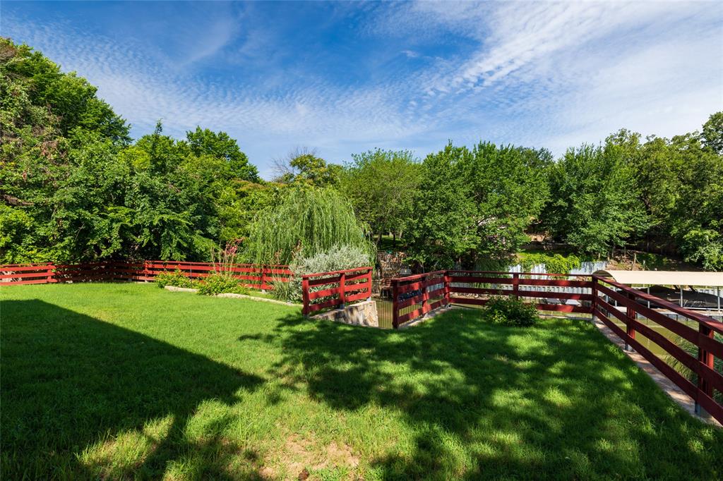 205 Timberlake Drive Azle, TX 76020 - Photo 32 of 40 a backyard of a house with lots of green space and outdoor seating