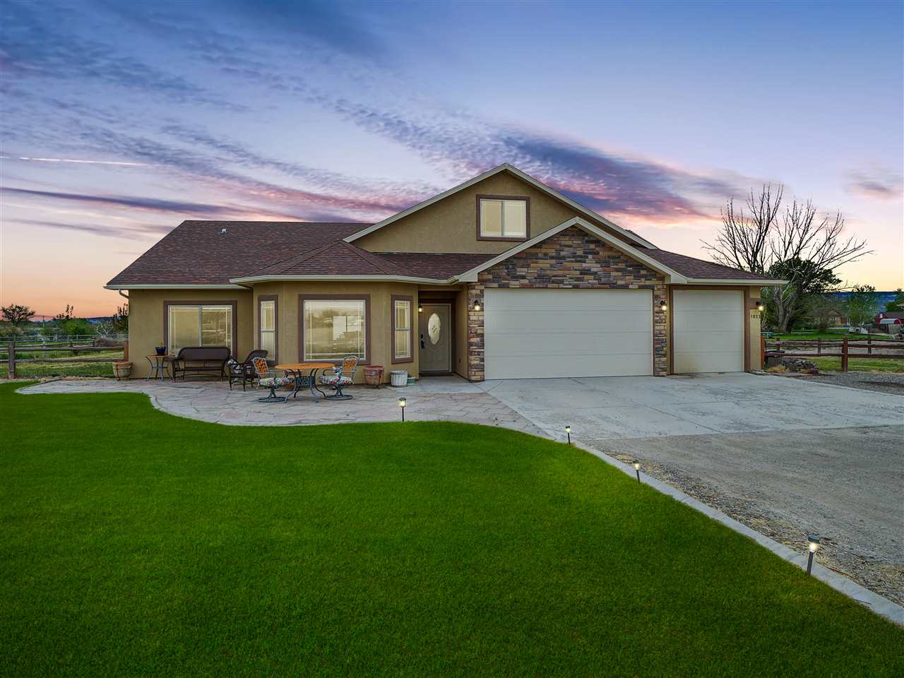 1853 Golden Ranch Road Fruita, CO 81521 - Photo 1 of 30 a front view of a house with yard patio and green space