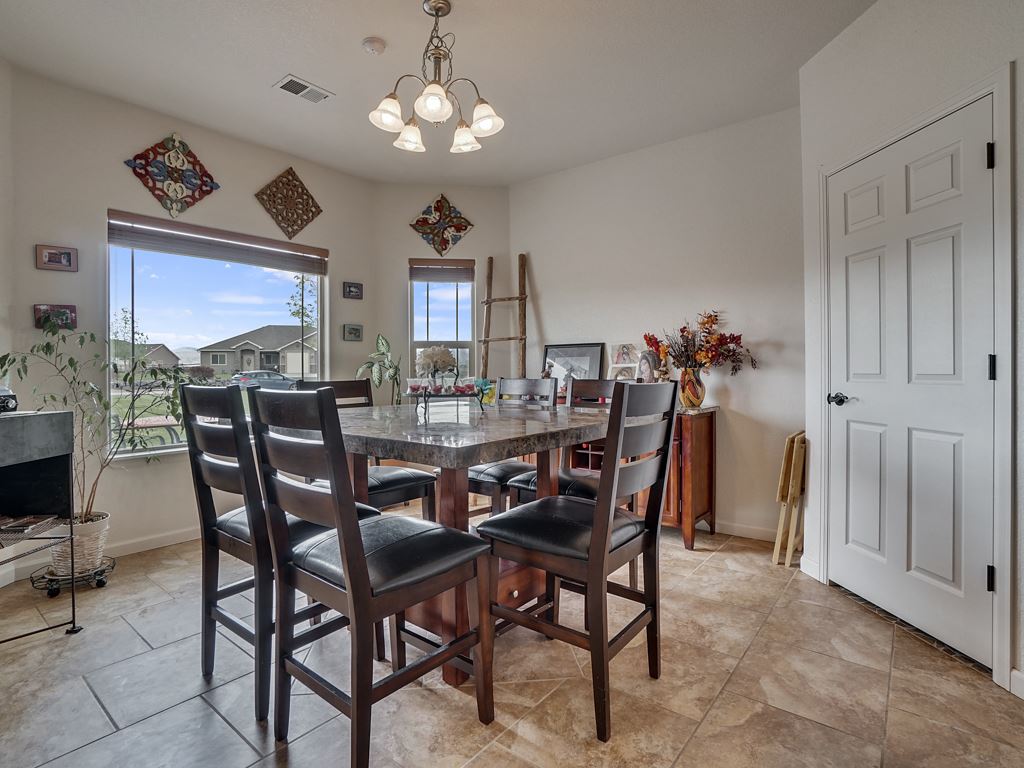 1853 Golden Ranch Road Fruita, CO 81521 - Photo 11 of 30 a view of a dining room with furniture and chandelier