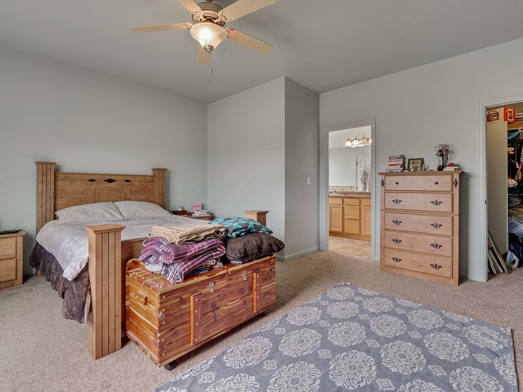 1853 Golden Ranch Road Fruita, CO 81521 - Photo 12 of 30 a bedroom with a bed and a cabinets