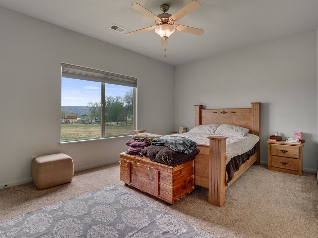 1853 Golden Ranch Road Fruita, CO 81521 - Photo 13 of 30 a bedroom with a bed and window