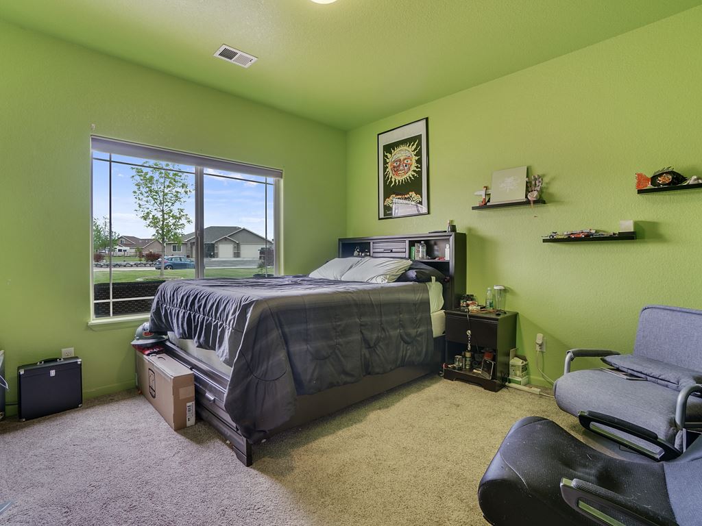 1853 Golden Ranch Road Fruita, CO 81521 - Photo 18 of 30 a bedroom with a bed and a dresser
