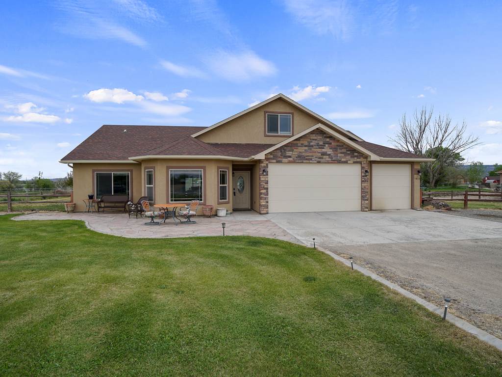 1853 Golden Ranch Road Fruita, CO 81521 - Photo 22 of 30 a front view of a house with yard patio and green space