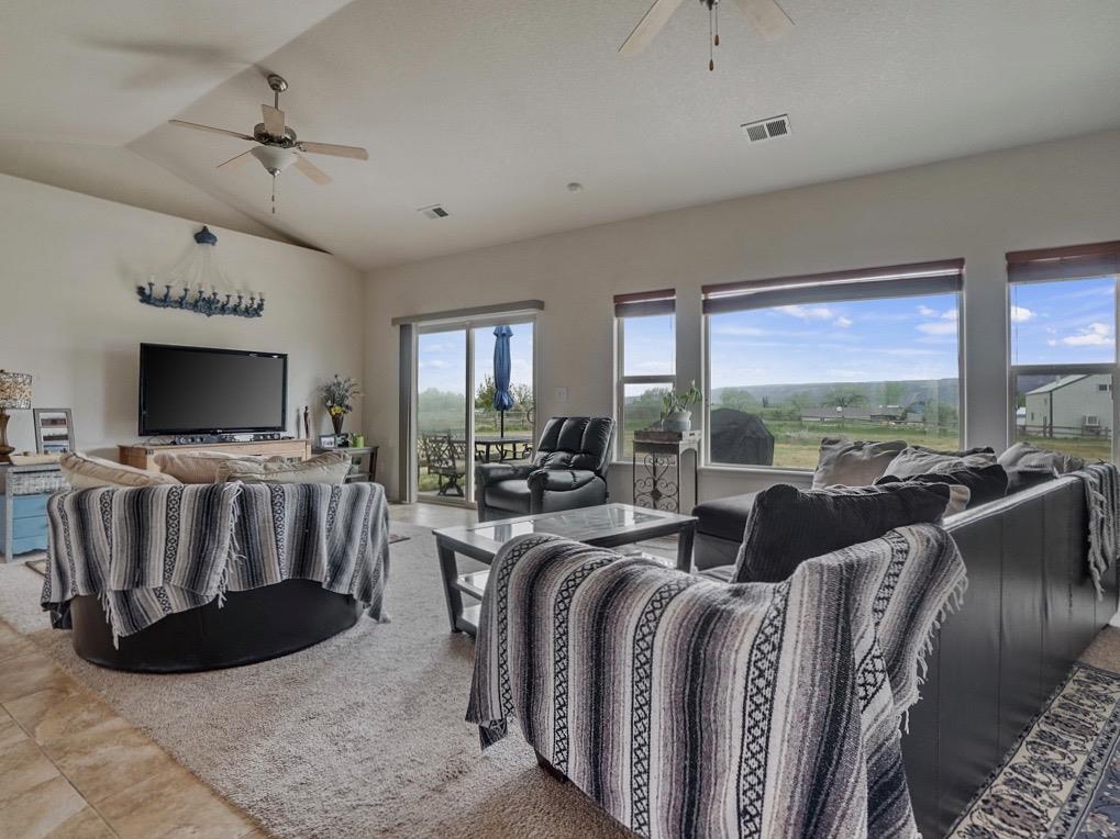 1853 Golden Ranch Road Fruita, CO 81521 - Photo 5 of 30 a living room with furniture a flat screen tv and floor to ceiling window