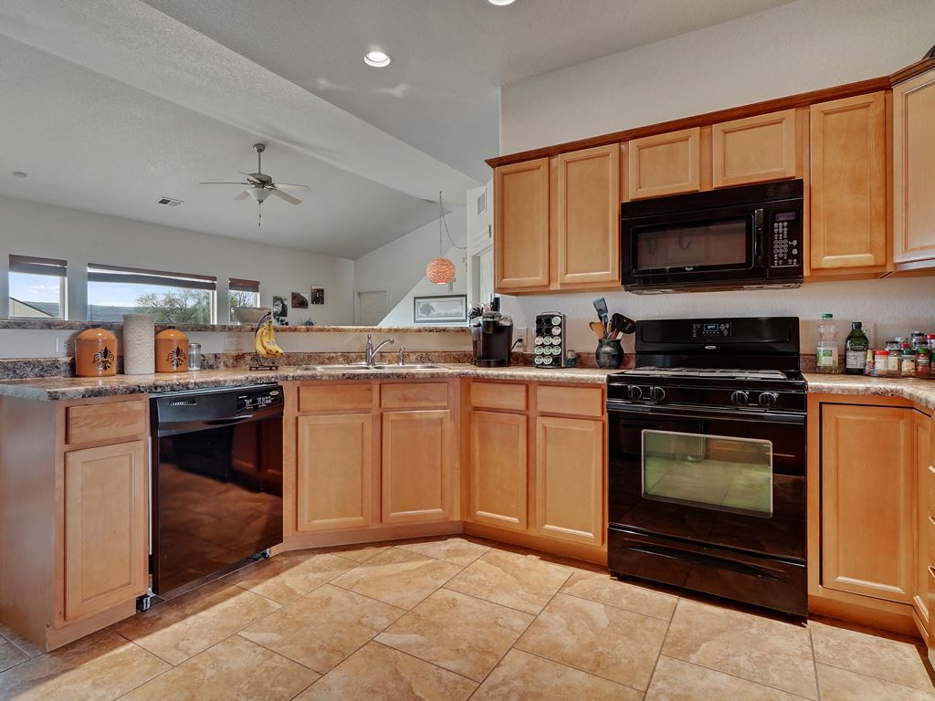 1853 Golden Ranch Road Fruita, CO 81521 - Photo 8 of 30 a kitchen with stainless steel appliances granite countertop a stove a sink and a microwave
