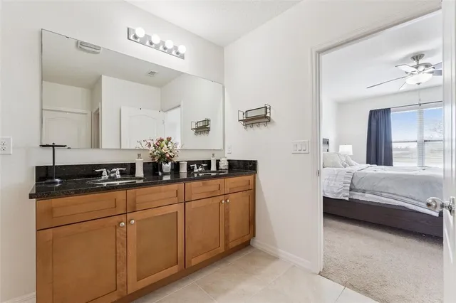 a en suite bathroom with double sink and a mirror