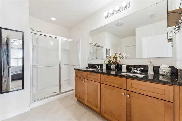 a kitchen with stainless steel appliances granite countertop white cabinets and a refrigerator