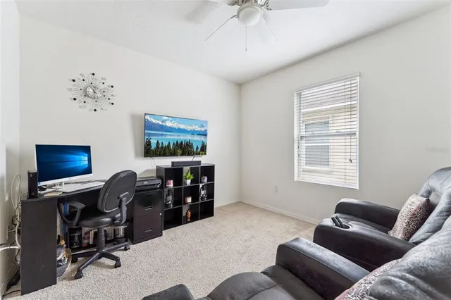 a livingroom with workspace and a window