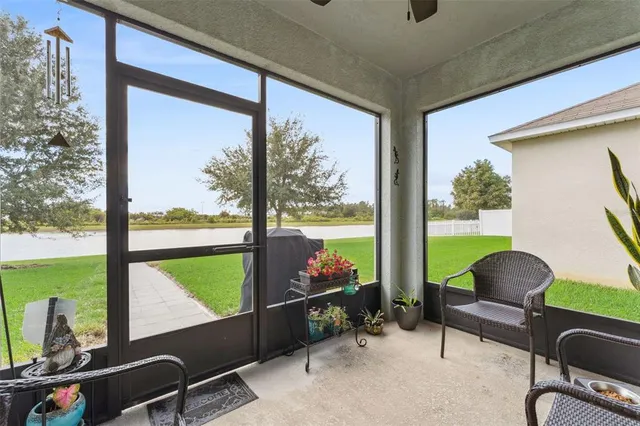 a view of a floor to ceiling window and chair in the room