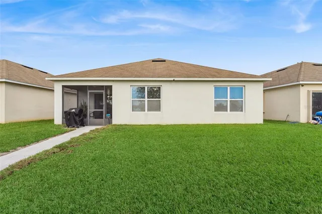 a view of a house with a backyard