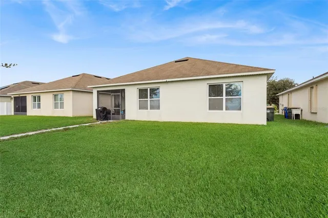 a view of a house with a backyard