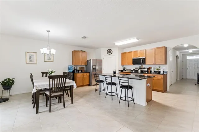 a living room with furniture and kitchen view