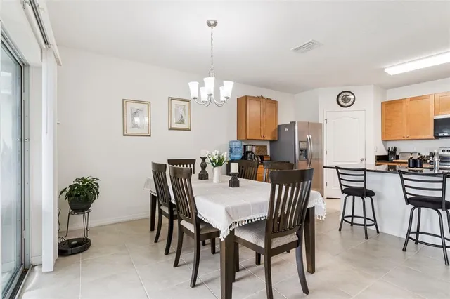 a view of a dining room with furniture and chandelier