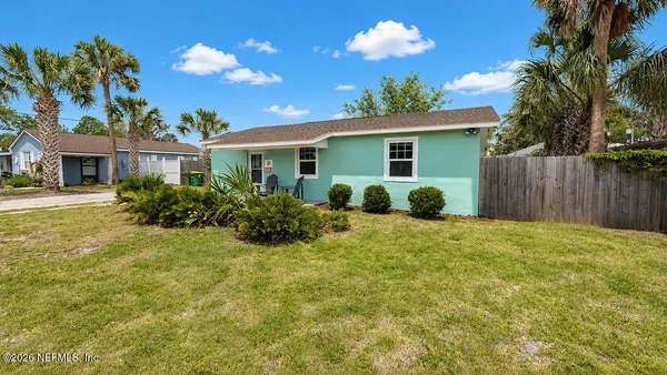 a view of a house with a backyard