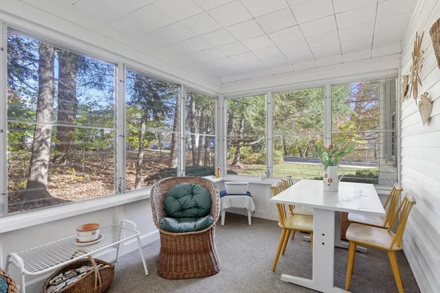 a dining room with furniture and a floor to ceiling window