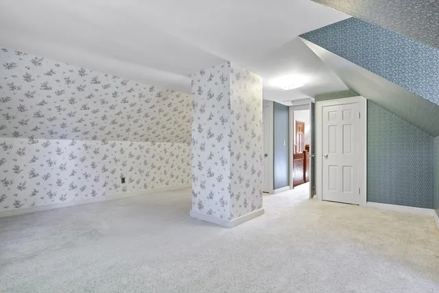 a view of a hallway with windows and chandelier