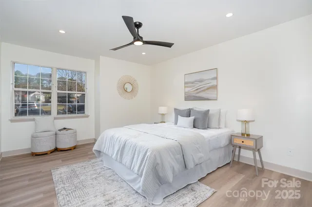 a bedroom with a large bed and a ceiling fan