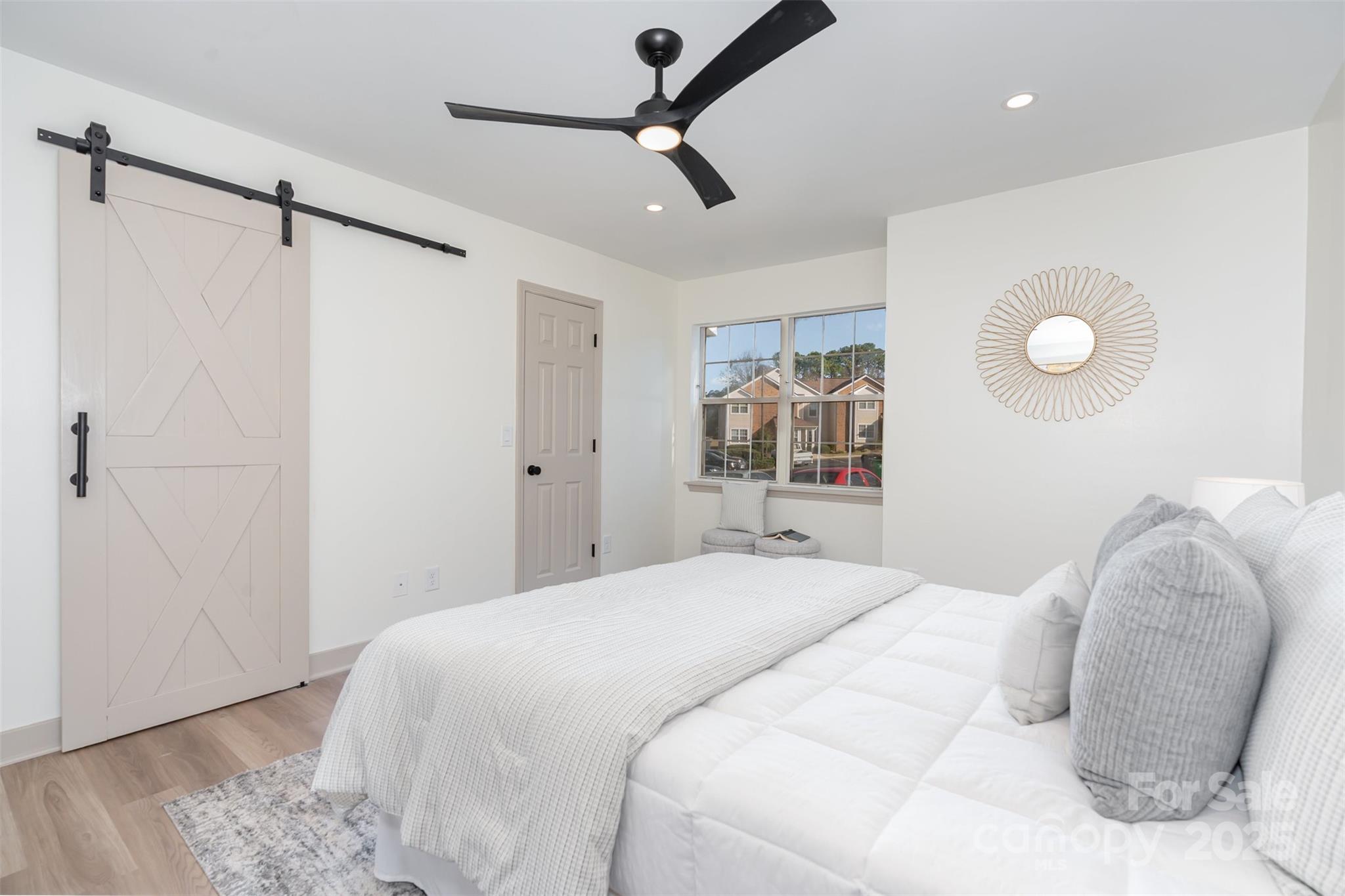 7802 Renaissance Court, Unit B Charlotte, NC 28226 - Photo 15 of 22 a bedroom with a bed and a window