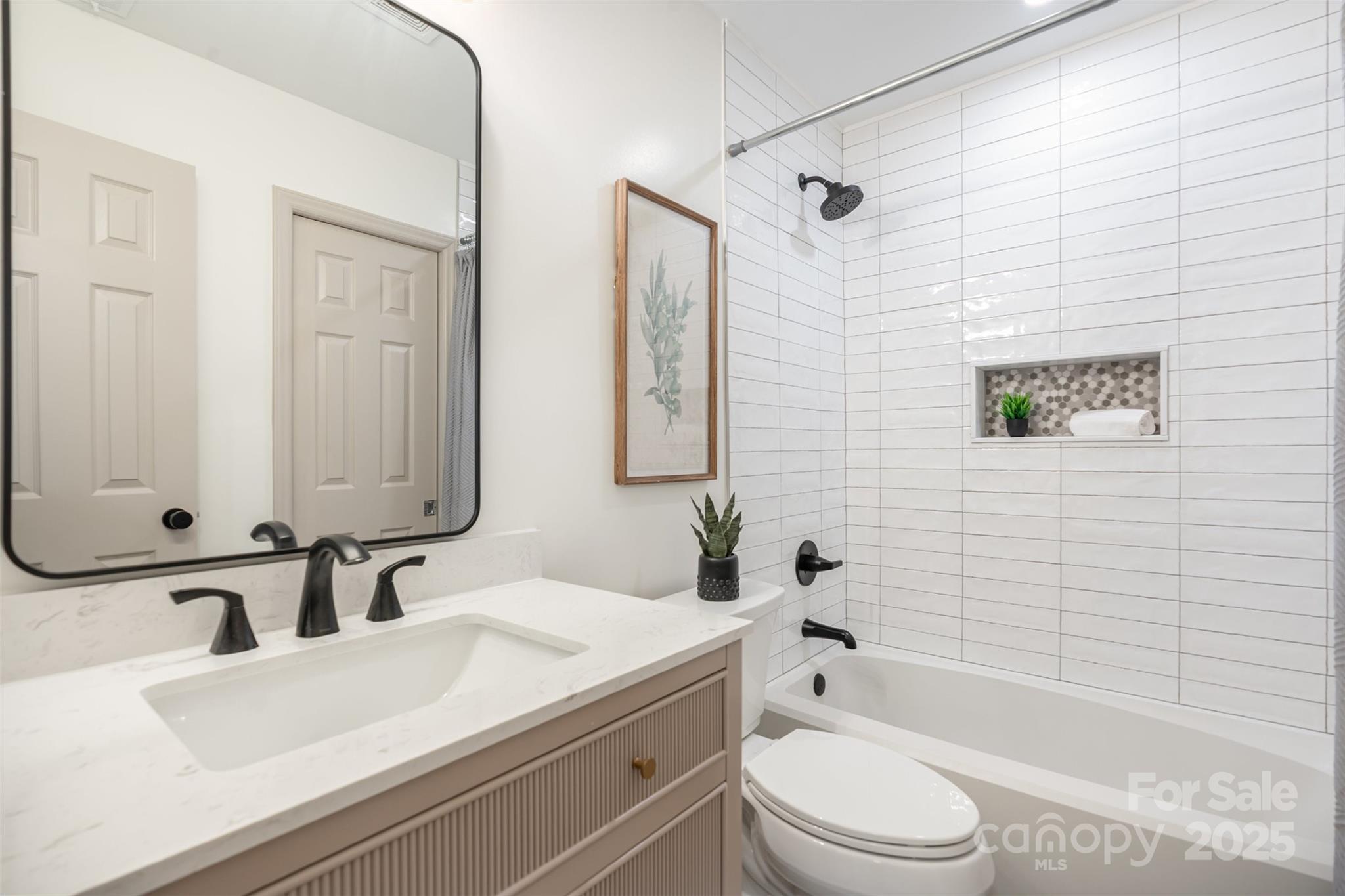 7802 Renaissance Court, Unit B Charlotte, NC 28226 - Photo 16 of 22 a bathroom with a sink a toilet and shower