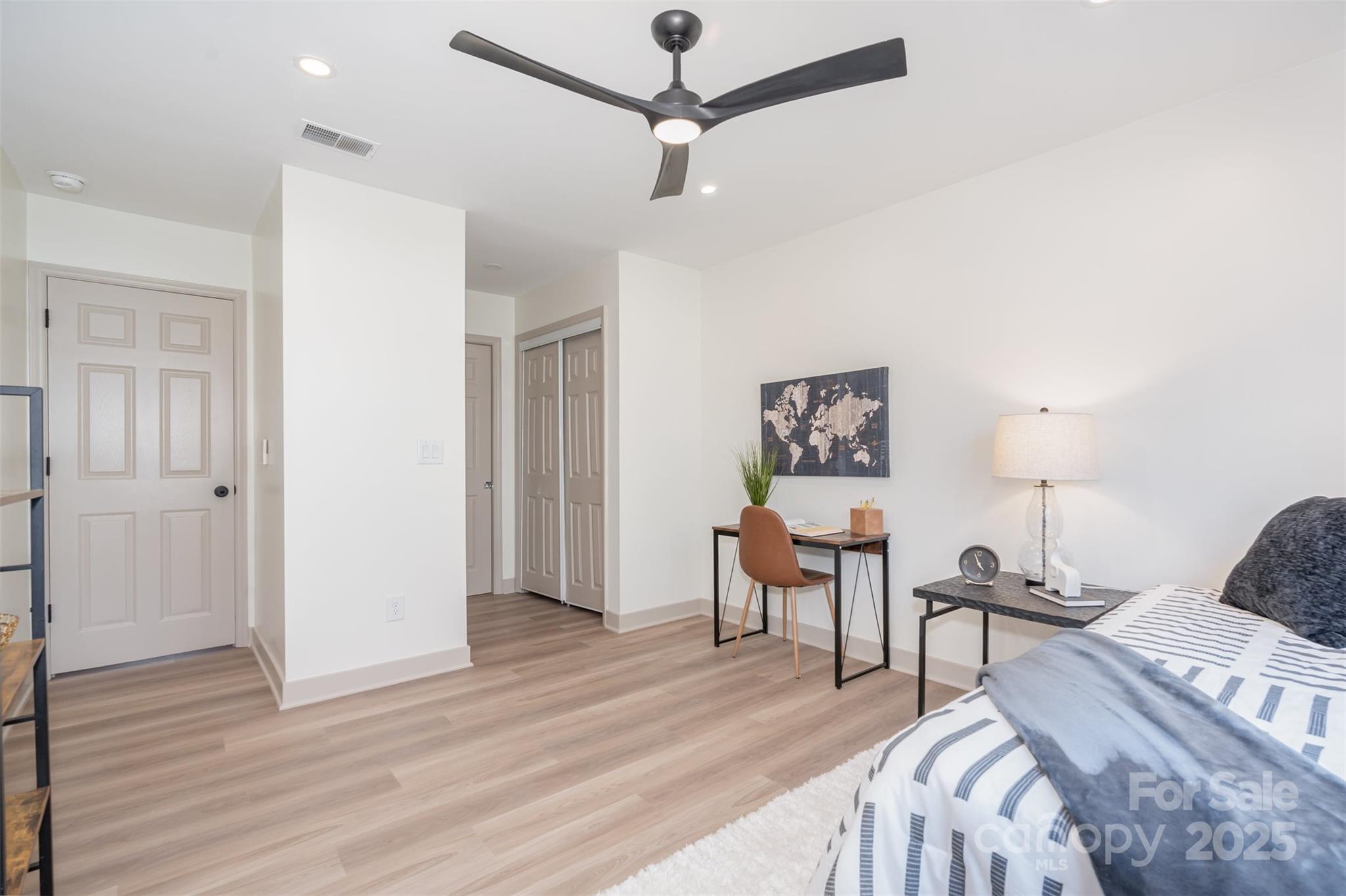 7802 Renaissance Court, Unit B Charlotte, NC 28226 - Photo 18 of 22 a bedroom with furniture and a wooden floor