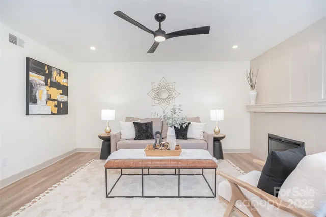 a living room with furniture a rug and a fireplace