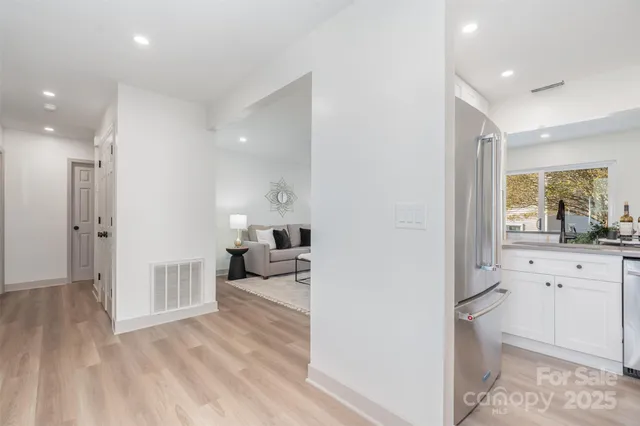 a view of a room with wooden floor and furniture