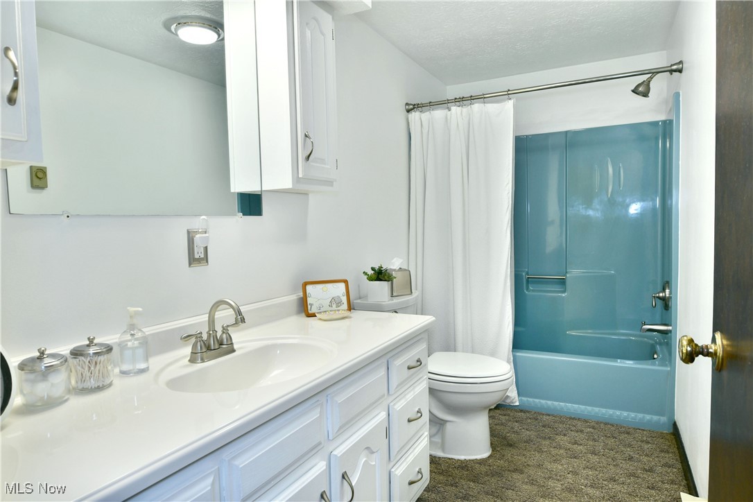 379 Housel Craft Road Bristolville, OH 44402 - Photo 34 of 50 Full bath with toilet, a textured ceiling, shower / bath combo, and vanity