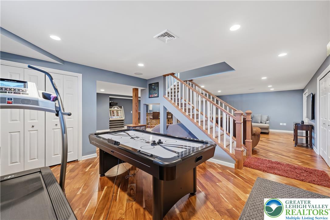 13 Country Road Northampton, PA 18067 - Photo 55 of 71 Entertaining space features lustrous wood flooring, recessed lighting, and a staircase with natural wood banisters.