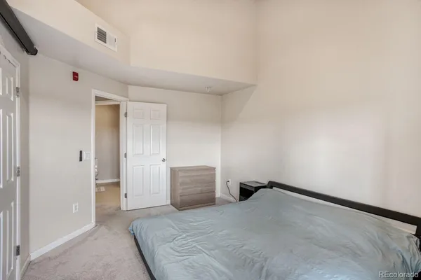 a bedroom with a bed and cabinets