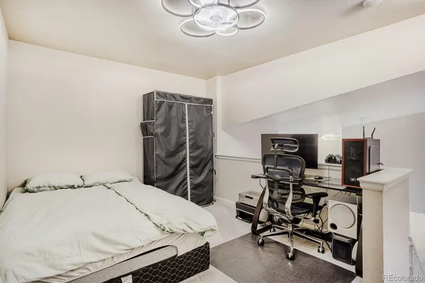 a bedroom with a bed and a chandelier