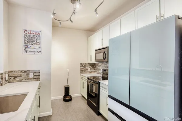 a kitchen with cabinets and stainless steel appliances
