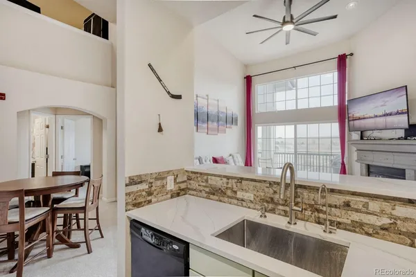 a kitchen with a sink a counter top space appliances and cabinets