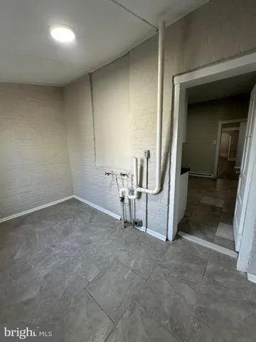 a view of a livingroom with wooden floor and furniture