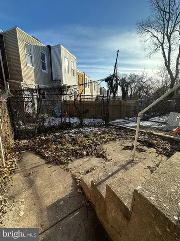 a view of a backyard with table and chairs