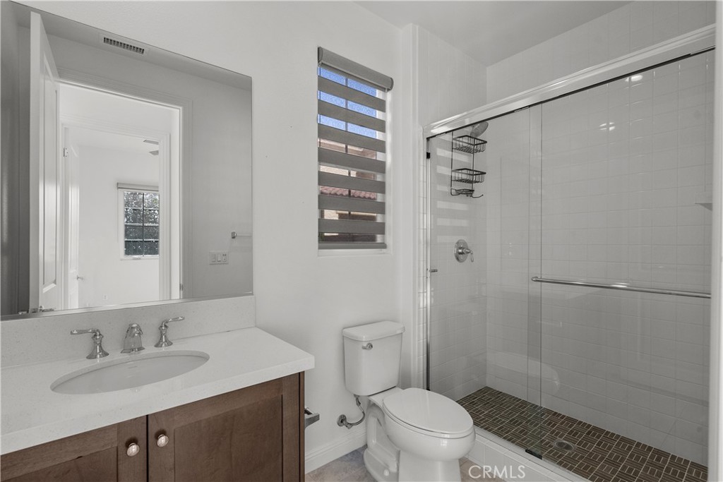 20828 Bur Oak Circle Porter Ranch, CA 91326 - Photo 13 of 43 a bathroom with a granite countertop sink toilet and shower