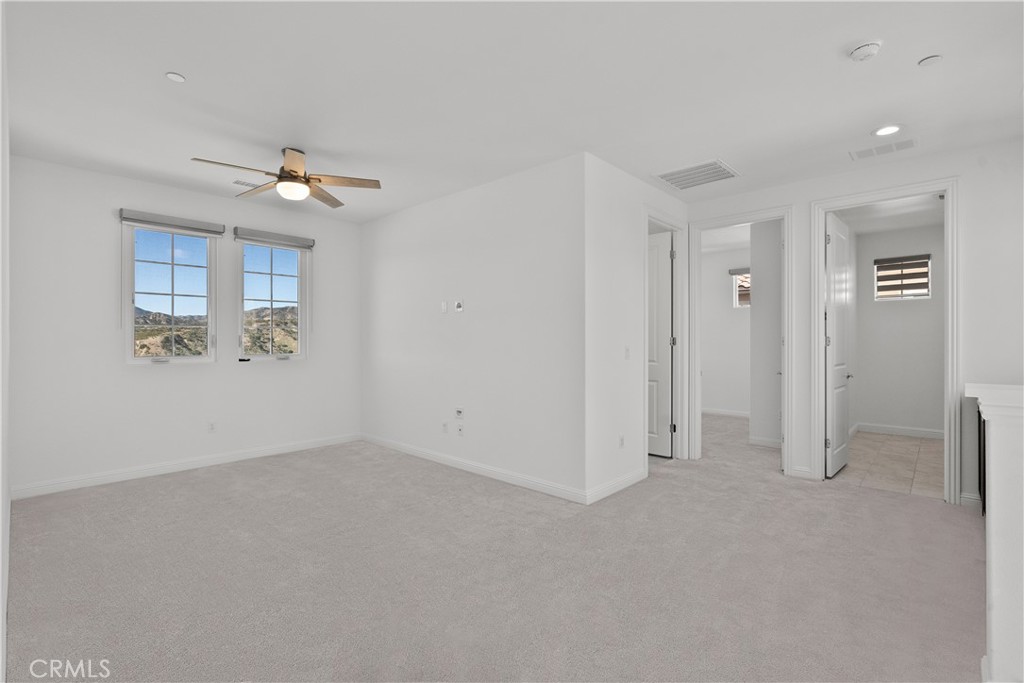 20828 Bur Oak Circle Porter Ranch, CA 91326 - Photo 15 of 43 an empty room with a empty space and a ceiling fan